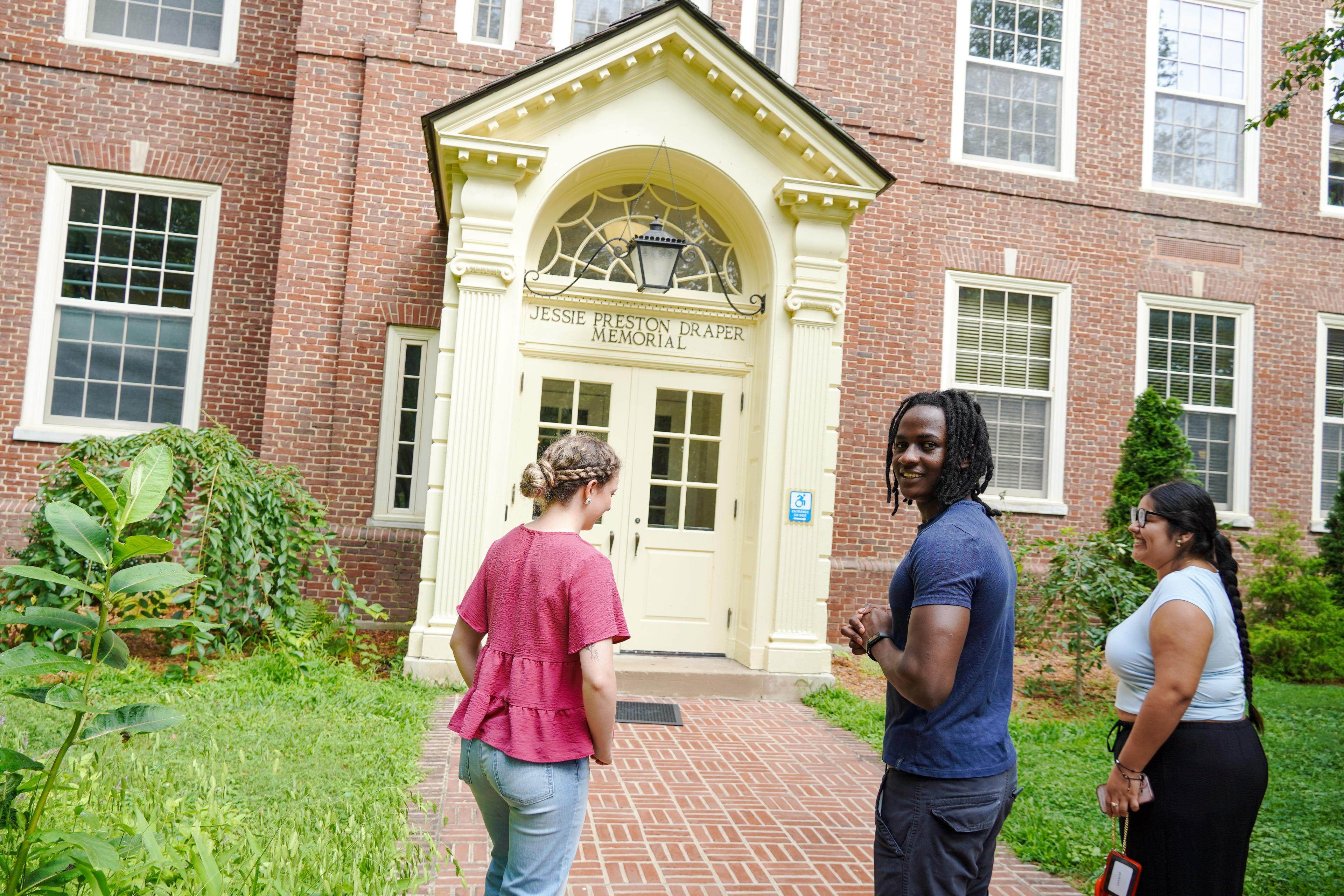 Three students standing in front of the Draper building.