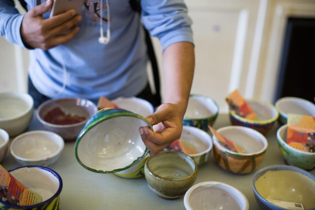 A person looks at ceramic bowls