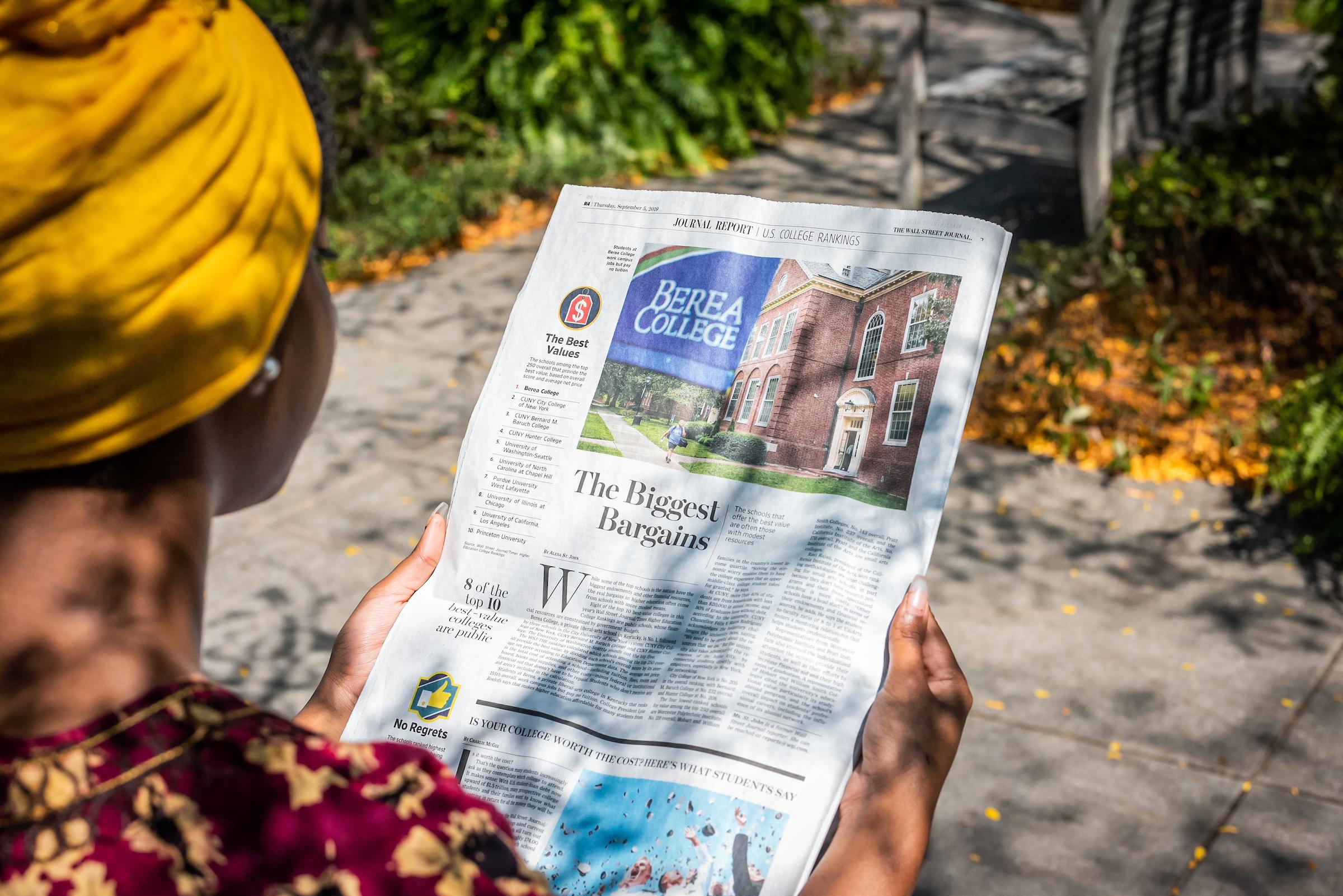 student reading newspaper featuring Berea College