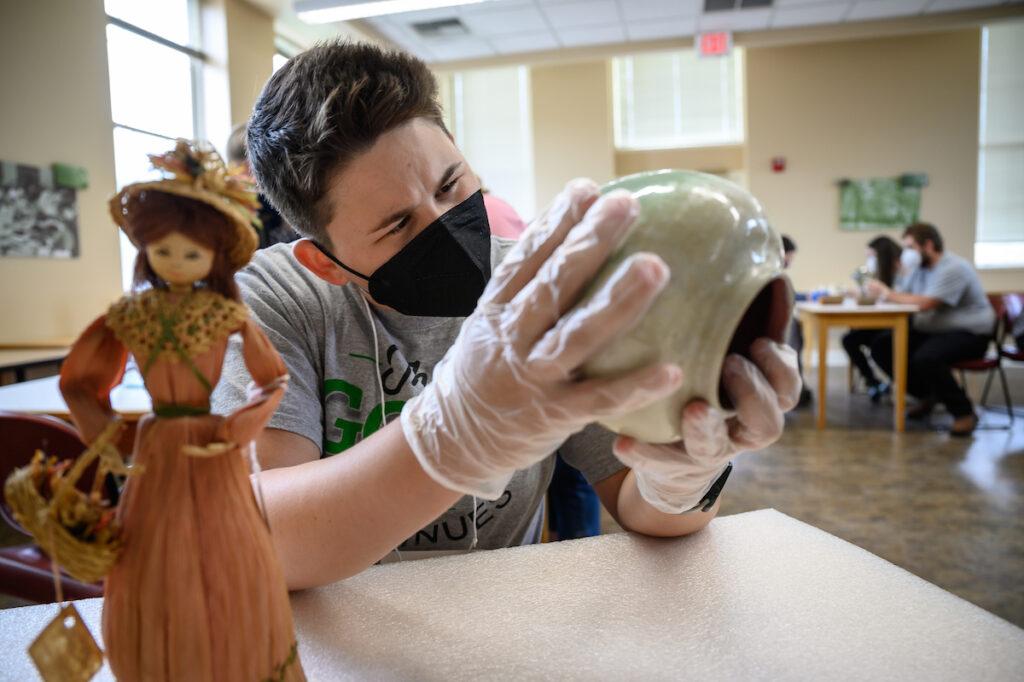 Berea College Alumna looking at artifacts from the College's collection